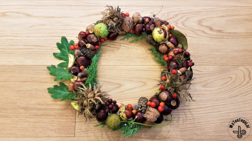 Autumn wreath with chestnuts, pine cones, acorns and nuts