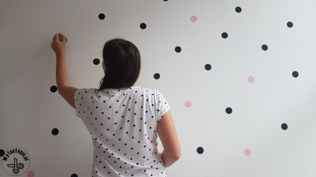 Painting polka dots on a wall