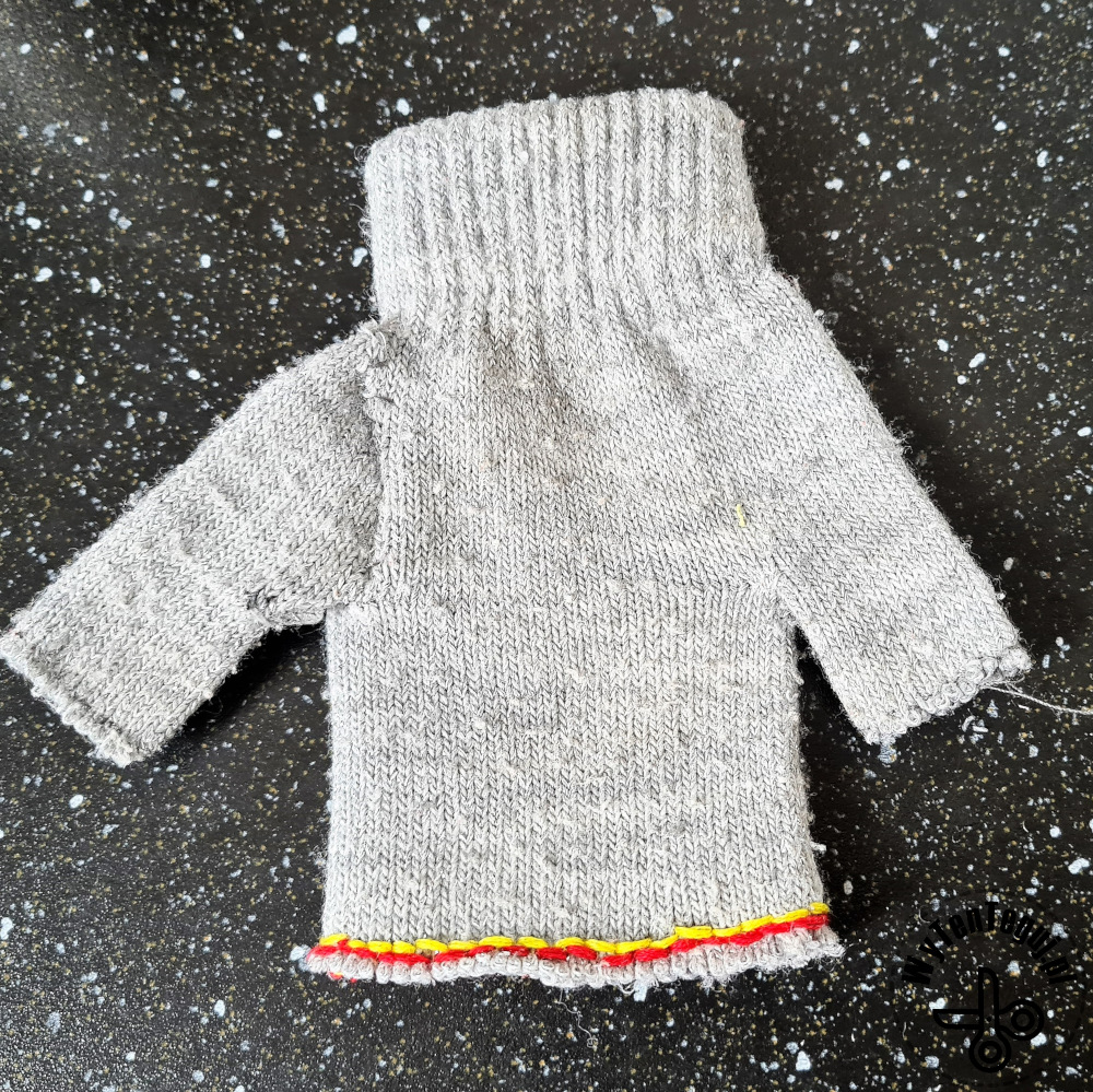 Preparing a sweater for a doll from gloves