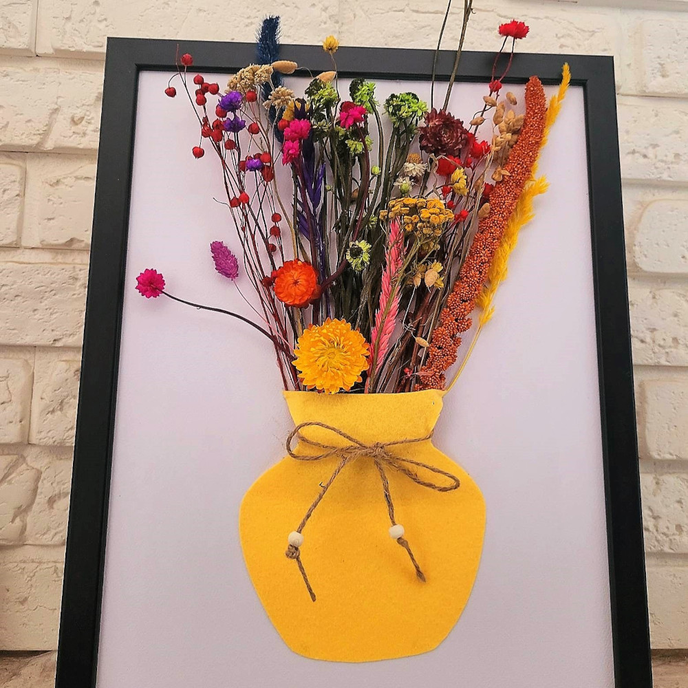 Felt vase with dried flowers in a frame